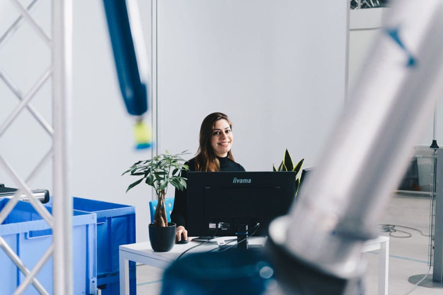 Employee working together with pick and place robot.